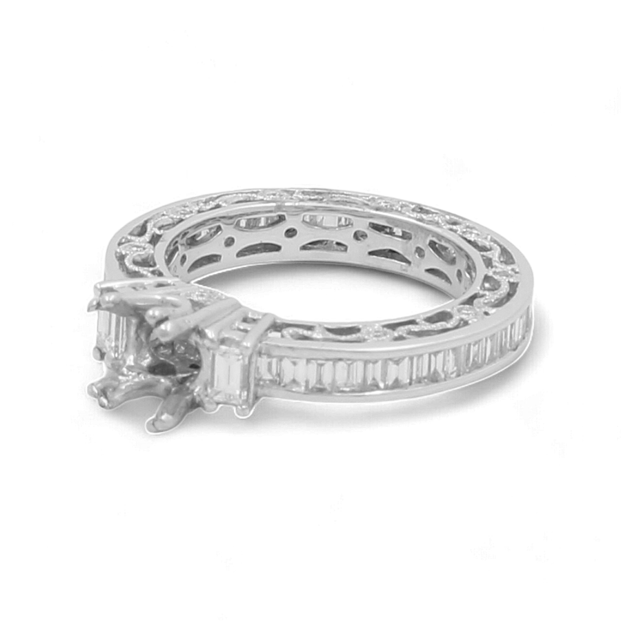 Introducing the 14K White Gold Bridal Woman's Ring with Diamonds by Miral Jewelry. This exquisite piece features detailed engravings, a central empty setting awaiting your choice of gemstone, and a band adorned with stunning rectangular-cut diamonds. It's the perfect finishing touch for your wedding day ensemble.