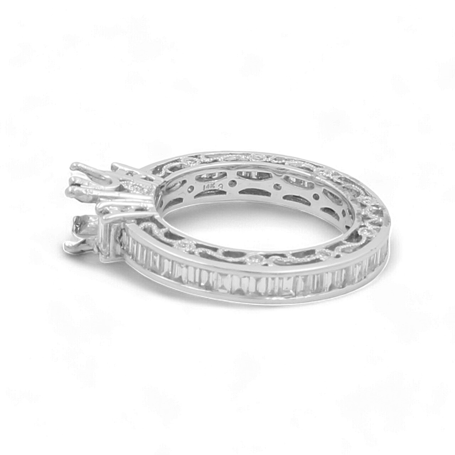 The Miral Jewelry 14K White Gold Bridal Woman's Ring with Diamonds features a stunning silver band encrusted with small, rectangular diamonds and an empty prong setting, making it perfect for completing any wedding day ensemble.