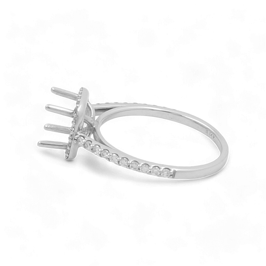 The Miral Jewelry 14K White Gold Bridal Woman's Ring with Diamonds boasts a prong setting designed to hold a gemstone, adorned with smaller diamonds embedded along the band—perfect for completing your wedding day ensemble.