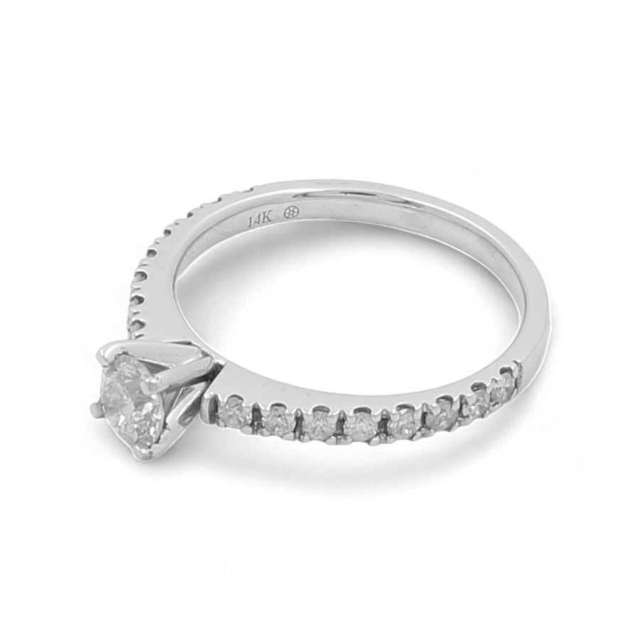 The Miral Jewelry 14K White Gold Bridal Woman's Ring with Diamonds is a stunning piece, showcasing a round diamond solitaire centerpiece and adorned with smaller diamonds along the band, making it an ideal timeless bridal ring.