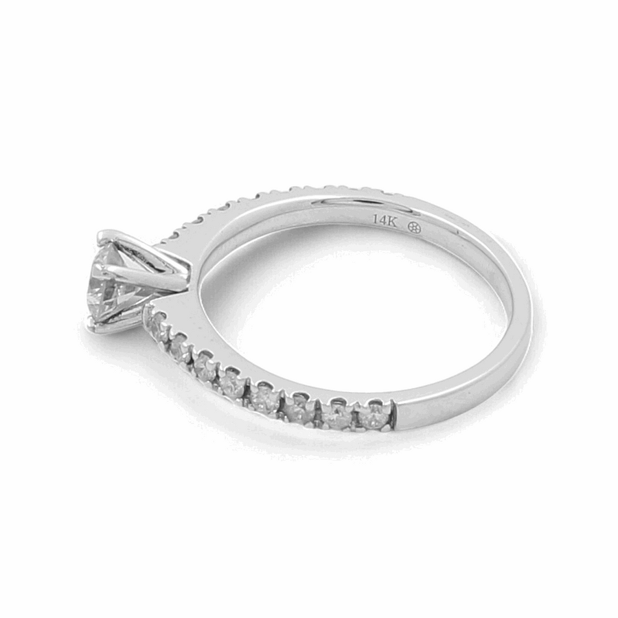 Introducing the 14K White Gold Bridal Woman's Ring with Diamonds from Miral Jewelry, showcasing a stunning round diamond in a prong setting and smaller diamonds embellishing the top half of the band.