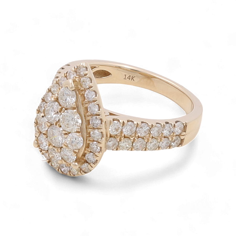 Miral Jewelry's 14K Yellow Gold Bridal Woman Ring with Diamonds is a stunning piece, featuring a teardrop-shaped cluster of white diamonds and a band adorned with additional diamonds, perfect as part of a bridal set.