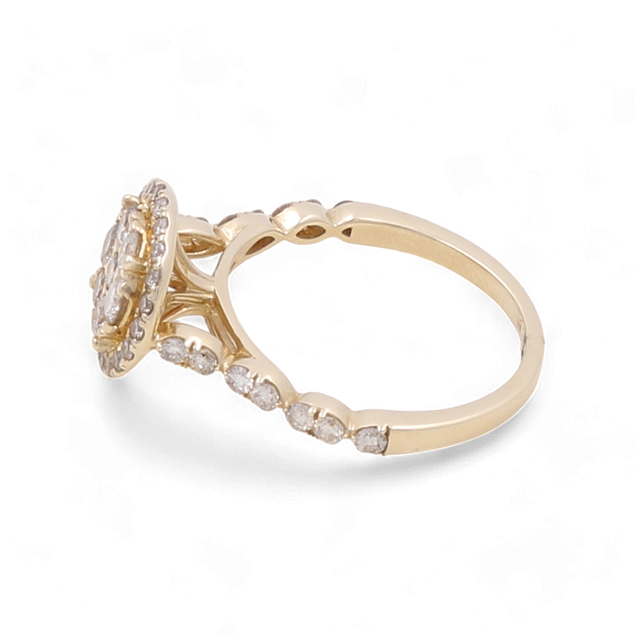 The 14K Yellow Gold Bridal Woman Ring with Diamonds by Miral Jewelry is a stunning piece featuring an oval-shaped center setting and multiple small diamonds accentuating the band, making it perfect for any bride.