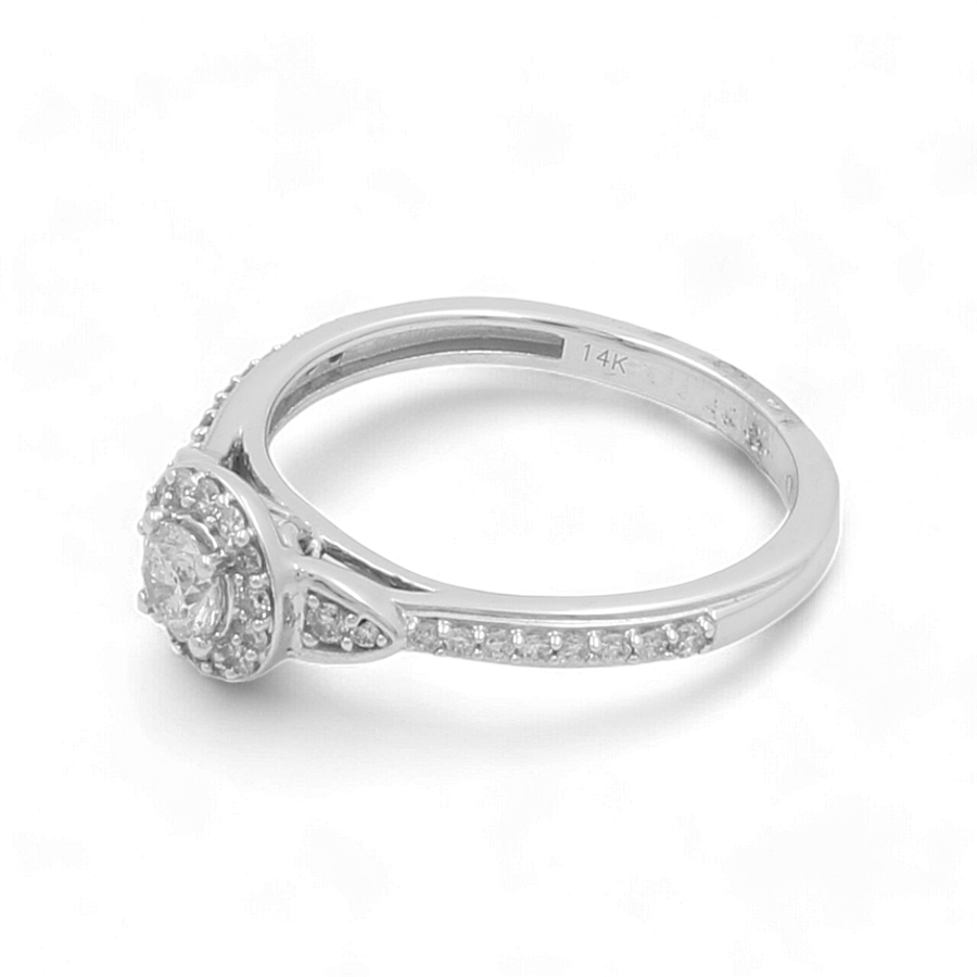 The 14K White Gold Bridal Woman Ring with Diamonds by Miral Jewelry features a round center diamond surrounded by a dazzling halo of smaller diamonds on the band.