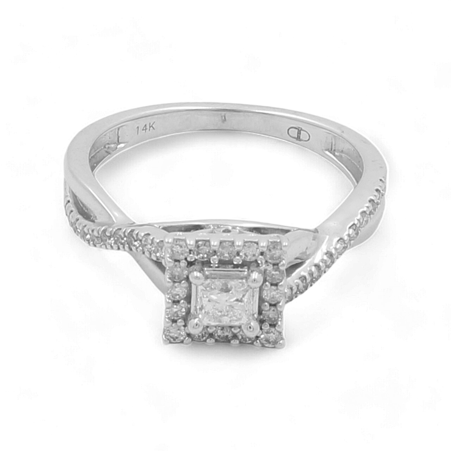 The Miral Jewelry 14K White Gold Bridal Woman Ring with Diamonds features a square-shaped diamond in a prong setting, surrounded by a halo of smaller diamonds. The elegantly twisted band is adorned with additional small diamonds.