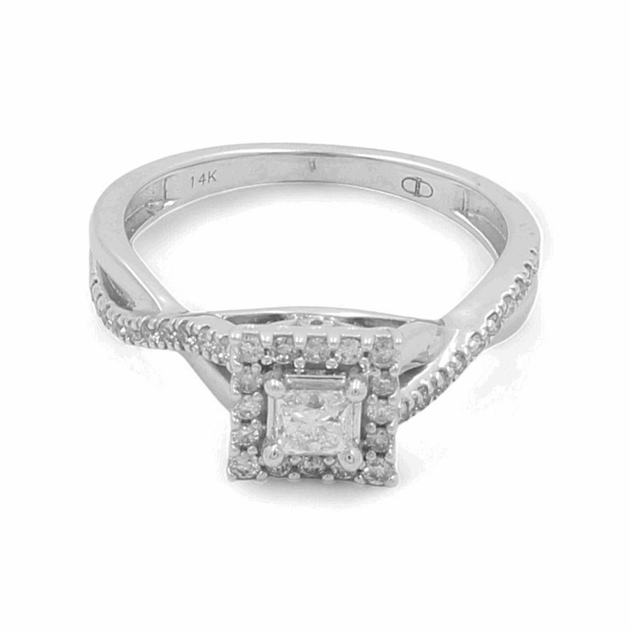 The Miral Jewelry 14K White Gold Bridal Woman Ring with Diamonds features a square-shaped diamond in a prong setting, surrounded by a halo of smaller diamonds. The elegantly twisted band is adorned with additional small diamonds.