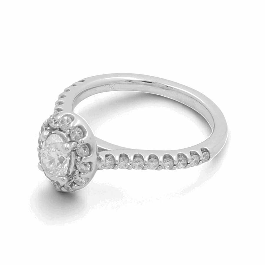 The 14K White Gold Bridal Woman Ring with Diamonds by Miral Jewelry showcases a central round diamond encircled by smaller diamonds, with additional small diamonds embellishing the band.