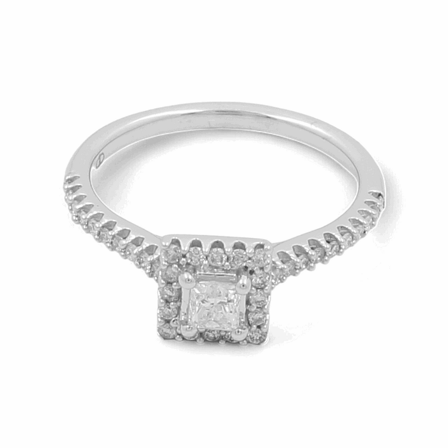 A stunning 14K White Gold Bridal Woman Ring by Miral Jewelry, featuring a silver band adorned with a square diamond centerpiece and surrounded by smaller dazzling diamonds along the band—a perfect engagement ring.