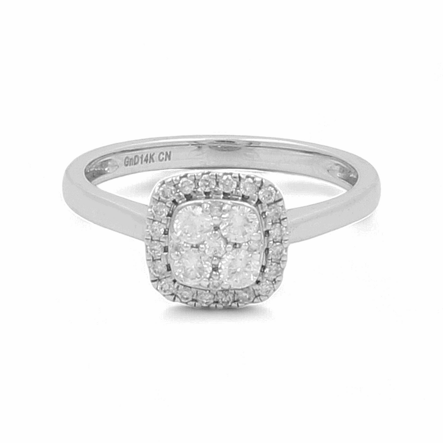 The 14K White Gold Bridal Woman Ring with Diamonds by Miral Jewelry features a stunning square arrangement of four central diamonds, elegantly encircled by a halo of smaller diamonds; an exquisite piece for any bride.