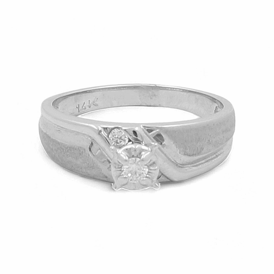 Introducing the breathtaking 14K White Gold Bridal Woman Ring with Zirconias by Miral Jewelry. This exquisite piece features a brilliant zirconia centerpiece and an intricate design. The elegantly crafted band is stamped with "14K," making it the perfect bridal ring for women.