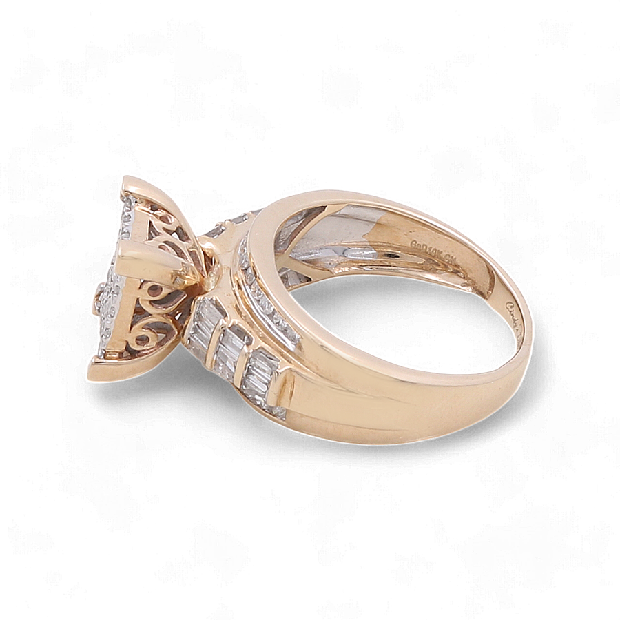 A bridal ring from Miral Jewelry, exquisitely crafted in 10K yellow gold, featuring a stunning diamond setting and intricate metalwork on the band.