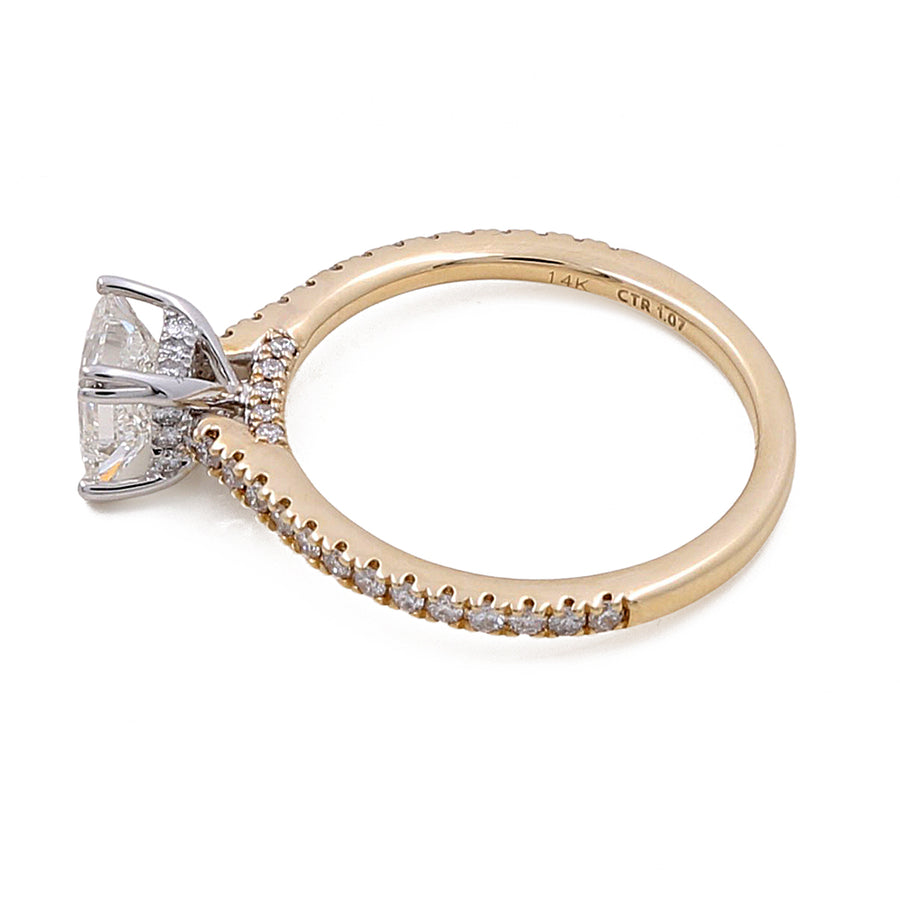 A **14K Yellow Gold Women's Contemporary Engagement Ring with 0.26Tw Round Diamonds** by **Miral Jewelry** featuring a large center diamond in a prong setting with smaller oval diamonds encrusted along the band.