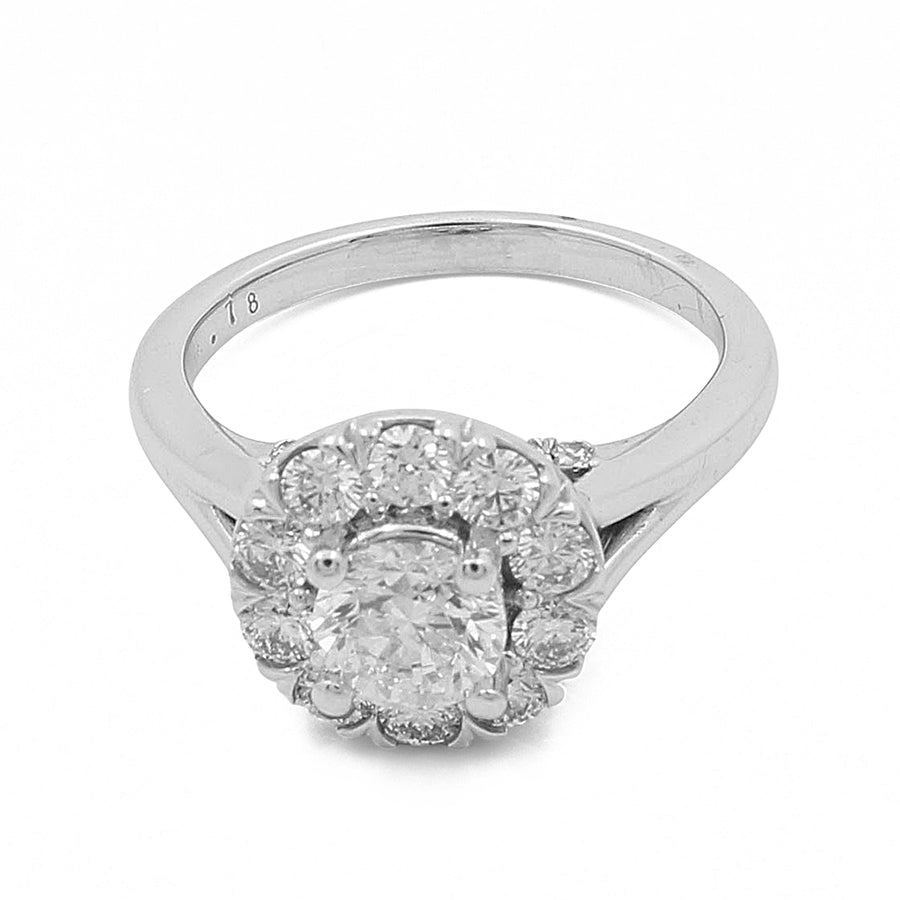 The Miral Jewelry 14K White Gold Women's Contemporary Engagement Ring with 0.75Tw Round Diamonds features a central round diamond surrounded by a halo of smaller diamonds.