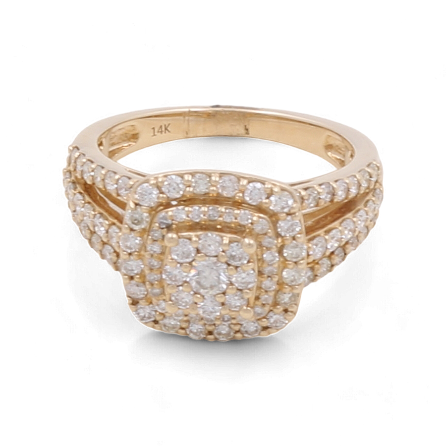 The "14K Yellow Gold Bridal Woman Ring with Diamonds" from Miral Jewelry is a luxurious 14K yellow gold bridal ring adorned with multiple small diamonds arranged in a rectangular pattern on the bezel and around the band.