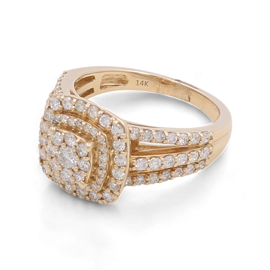 The 14K Yellow Gold Bridal Woman Ring with Diamonds by Miral Jewelry is a luxury gold ring featuring a square setting and multiple rows of small diamonds embedded on the band and around the central design. Despite being crafted in 10K yellow gold, it is marked as 14K on the inside.