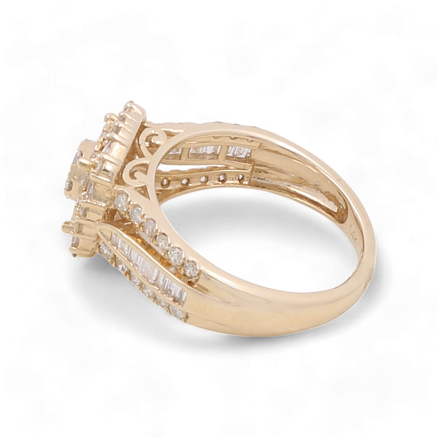 The 14K Yellow Gold Bridal Woman Ring with Diamonds by Miral Jewelry features intricate detailing, adorned with multiple small diamonds set along the band and crowned with a stunning 1 carat diamond on top.