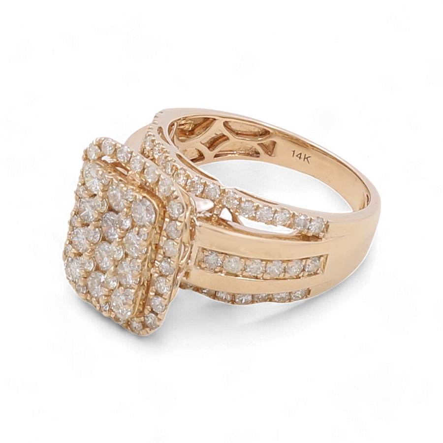 The Miral Jewelry 14K Yellow Gold Bridal Woman Ring with Diamonds showcases a prominent square setting adorned with numerous small diamonds, complemented by additional diamonds elegantly set along the band.