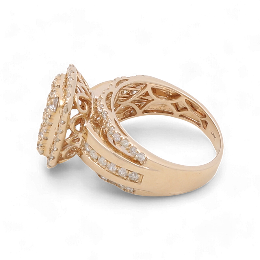 A 14K yellow gold bridal woman ring by Miral Jewelry, adorned with multiple small diamonds and featuring an intricate design along with a 14K engraving.