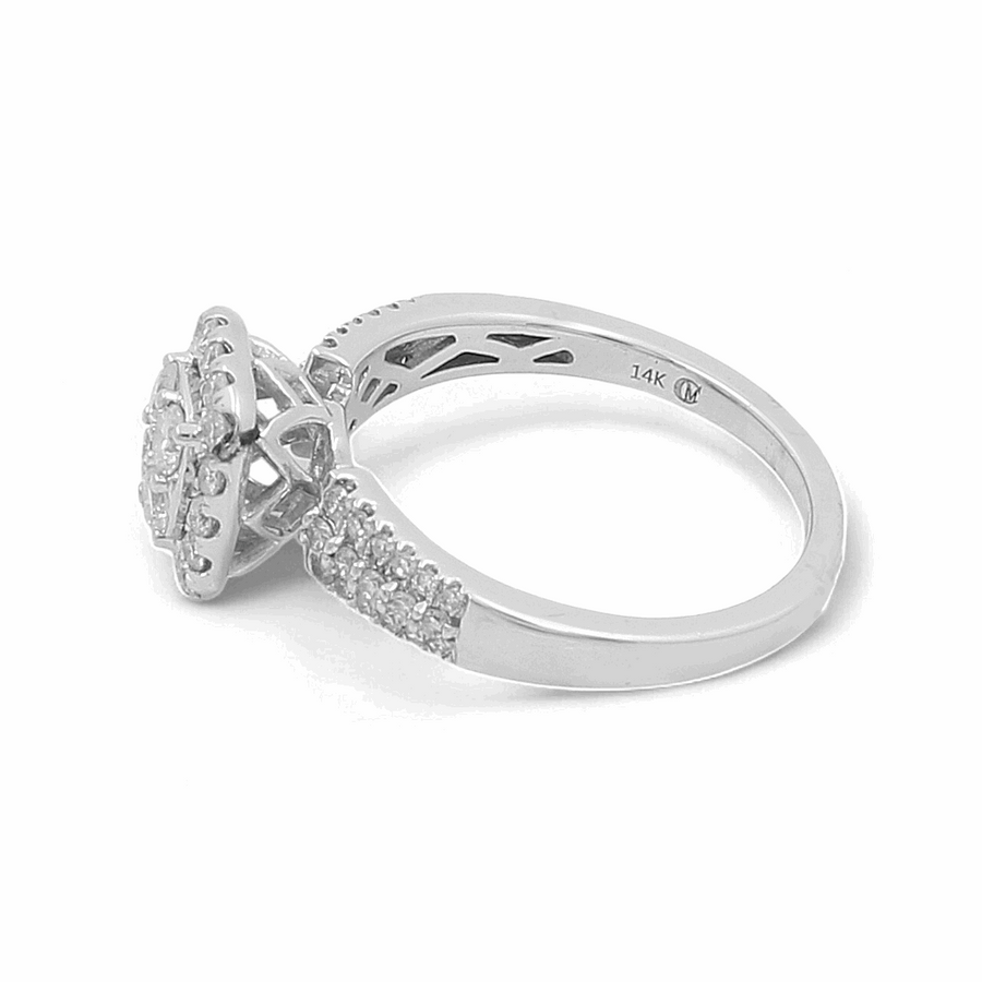 The 14K White Gold Bridal Woman Ring with Diamonds from Miral Jewelry showcases a stunning pave diamond band and a halo setting around the central diamond.