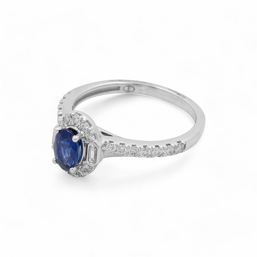 The Miral Jewelry 14K White Gold Woman Fashion Ring showcases an exquisite oval sapphire gemstone encircled by round diamonds, with additional small diamonds adorning parts of the band.