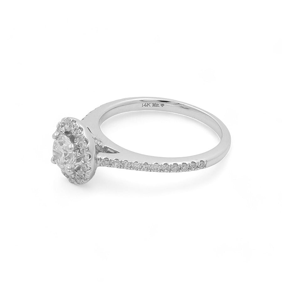 The Miral Jewelry 14K White Gold Women's Contemporary Engagement Ring showcases a central round diamond encircled by smaller diamonds in a stunning halo setting, complemented by additional round diamonds encrusted along the band.