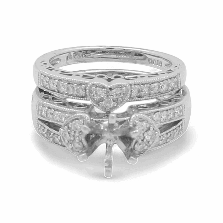 A close-up image of the 14K White Gold Bridal Woman Ring with Diamonds from Miral Jewelry, showcasing heart-shaped designs and embedded small diamonds. The rings feature intricate detailing and are elegantly displayed without a central gemstone.