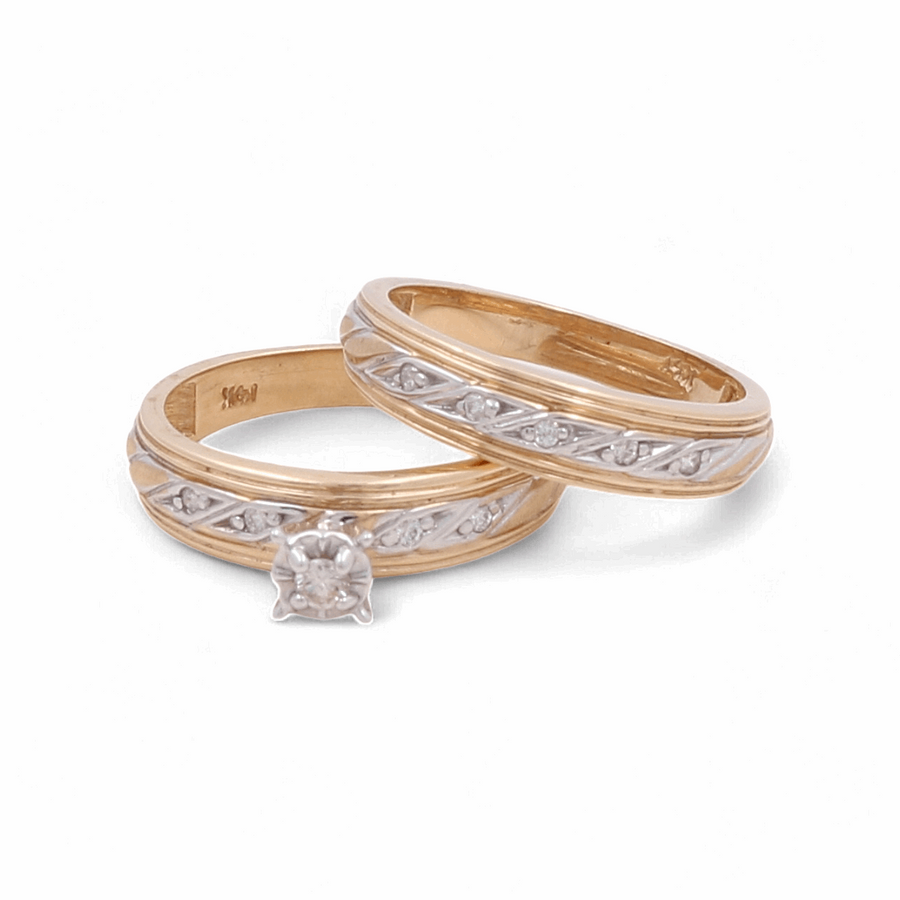 Two gold rings with intricate designs featuring white accents are displayed alongside an elegant 14K Yellow Gold Bridal Woman Ring from Miral Jewelry, adorned with diamonds in front. The gold rings have a 14K engraving inside, showcasing timeless jewelry craftsmanship.