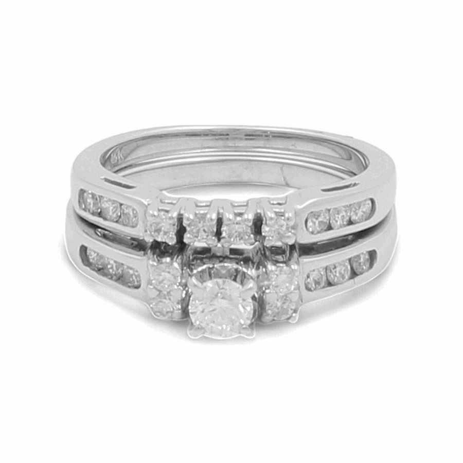 A close-up of the Miral Jewelry 14K White Gold Bridal Woman Ring with Diamonds showcases a prominent central diamond and smaller diamond accents along the band. This exquisite ring captures timeless elegance.