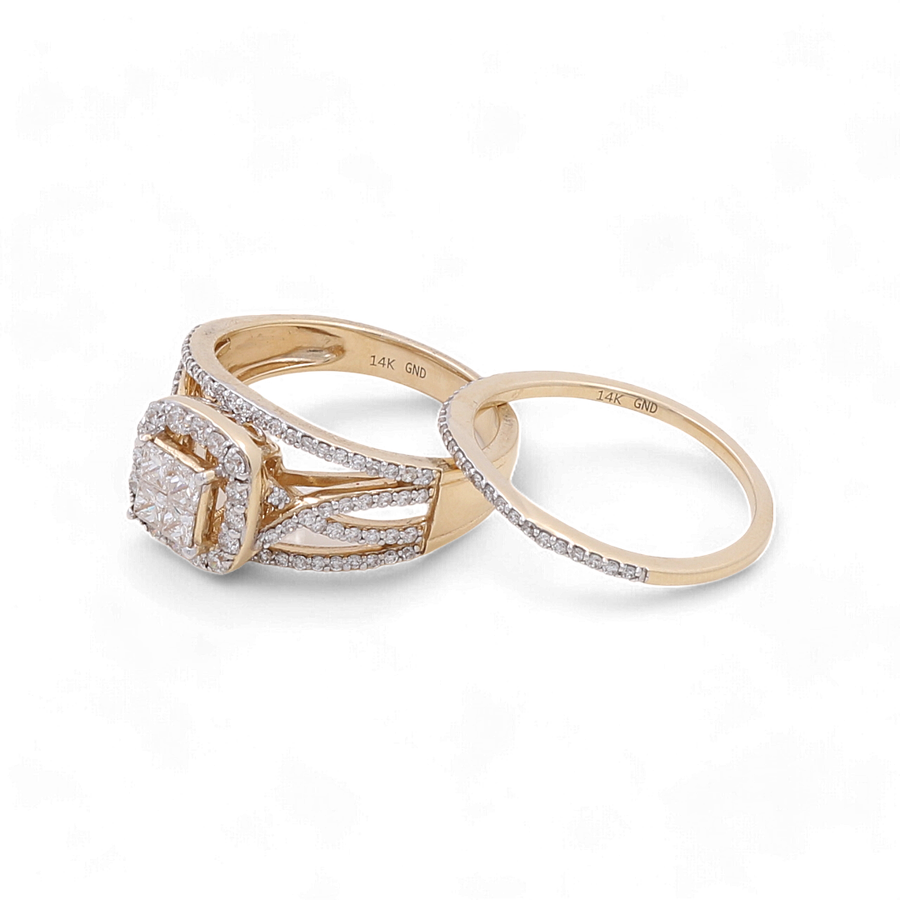 A stunning 14K yellow gold bridal ring set by Miral Jewelry, adorned with small diamonds, features a cushion-cut center stone on the engagement ring.