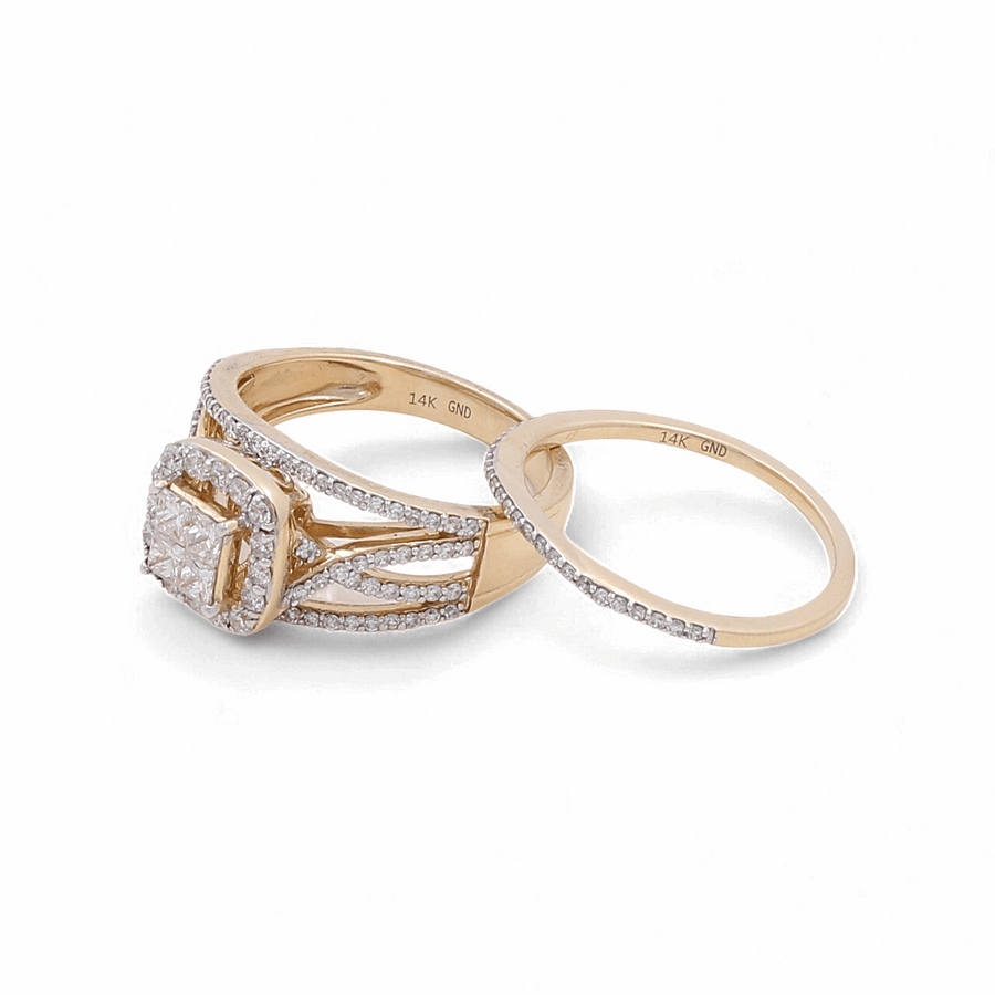 A stunning 14K yellow gold bridal ring set by Miral Jewelry, adorned with small diamonds, features a cushion-cut center stone on the engagement ring.