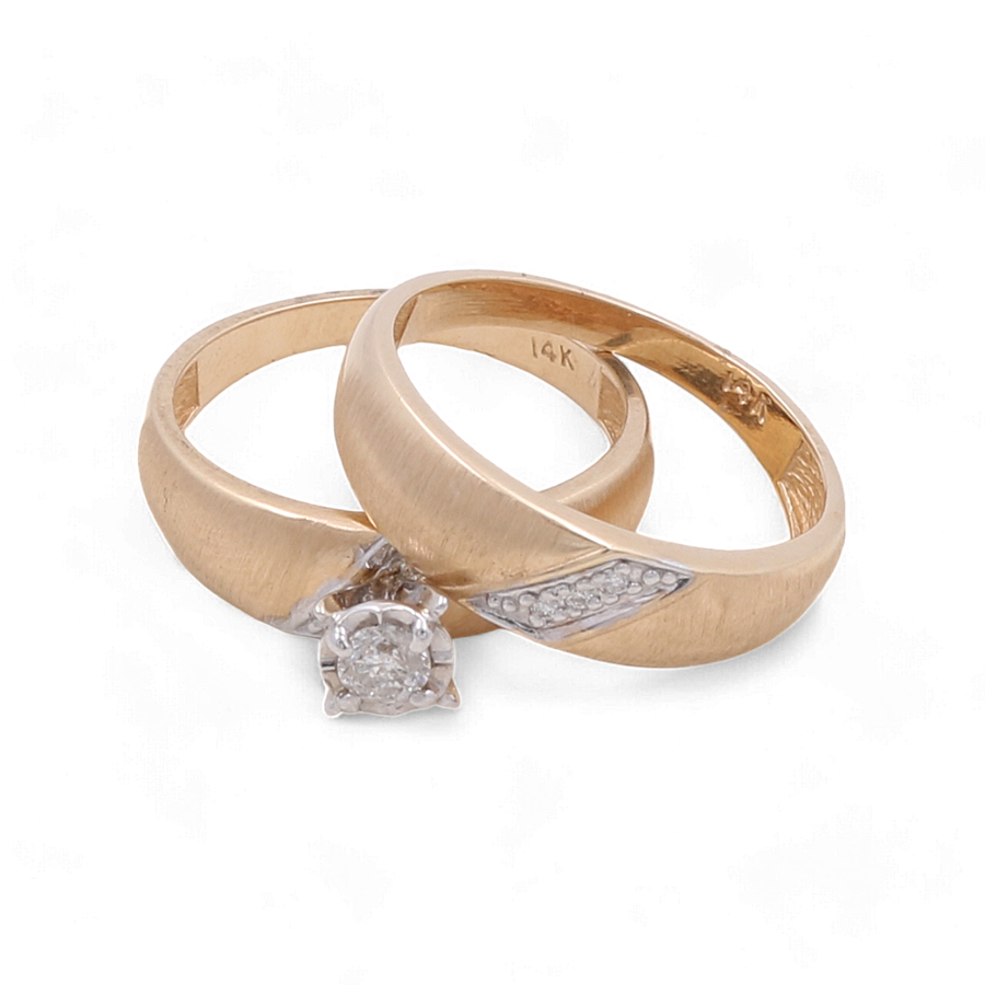 Two gold rings: one plain 14K yellow gold with a diamond solitaire; the other, a 14K Yellow Gold Bridal Woman Ring with Diamonds by Miral Jewelry, both marked "14K.