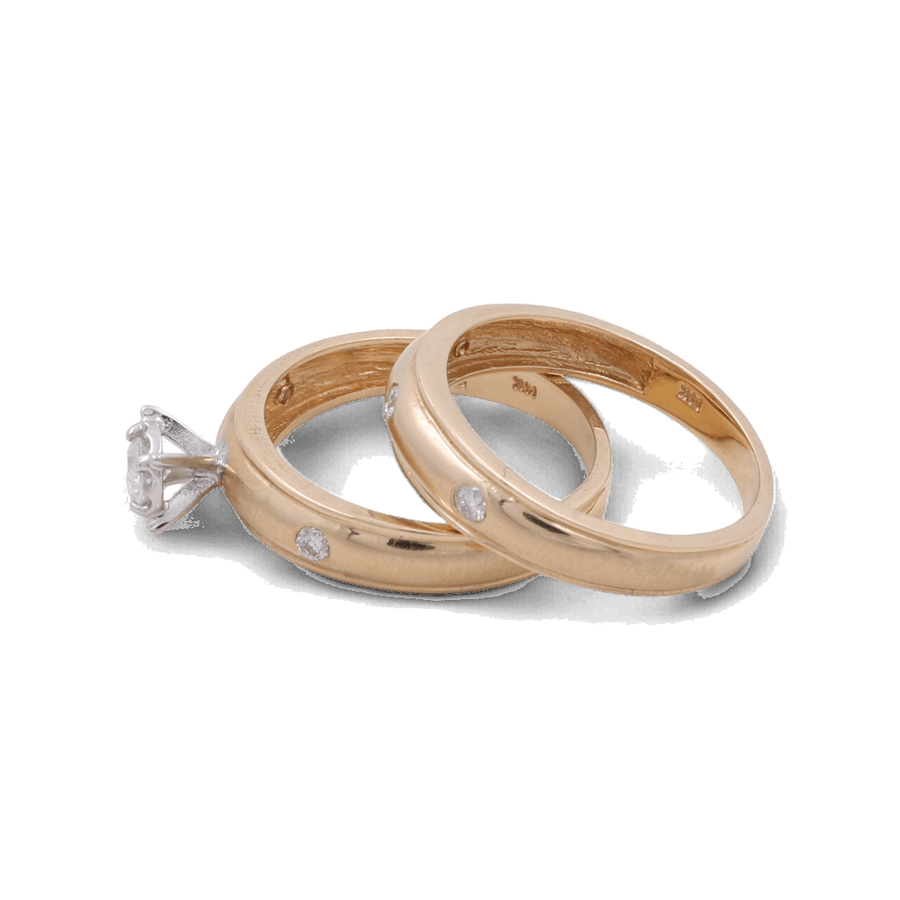 Two 14K yellow gold wedding bands by Miral Jewelry, each adorned with small diamonds, and one Miral Jewelry 14K Yellow Gold Bridal Woman Ring featuring a single large diamond, displayed against a plain background. Ideal for the discerning woman seeking the perfect bridal ring set.