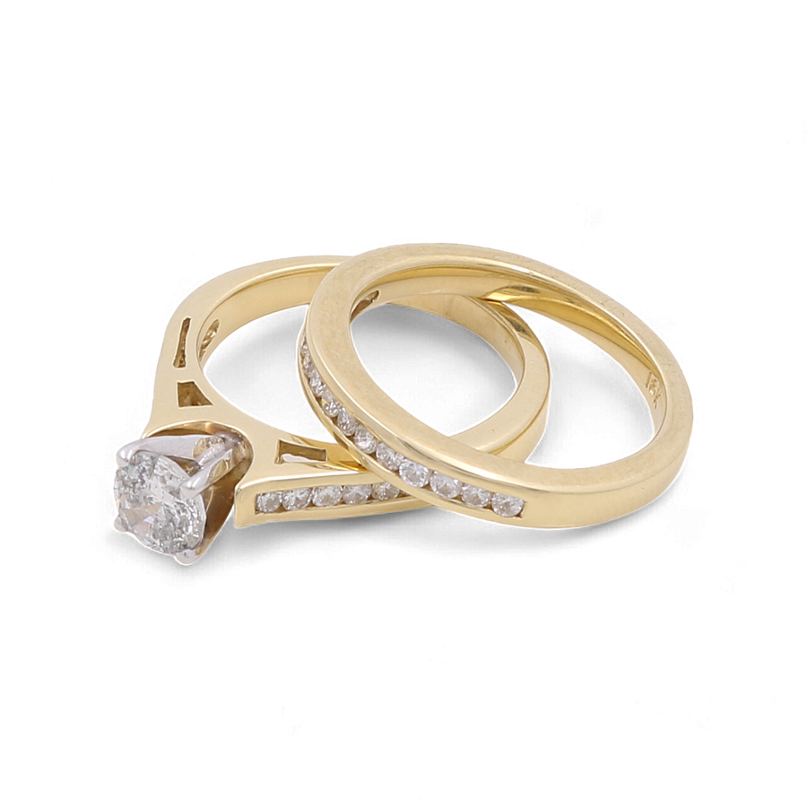 Two Miral Jewelry 10K yellow gold bridal women rings: one showcases a central diamond in a prong setting, and the other is an elegant plain band adorned with small diamonds along its top half.