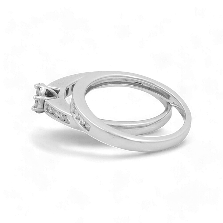 Two connected 10K white gold rings from Miral Jewelry are displayed against a white background. One ring features a raised central stone set in a prong setting, while the other showcases delicate diamonds. The product is named the 10K White Gold Bridal Woman Ring with Diamonds.