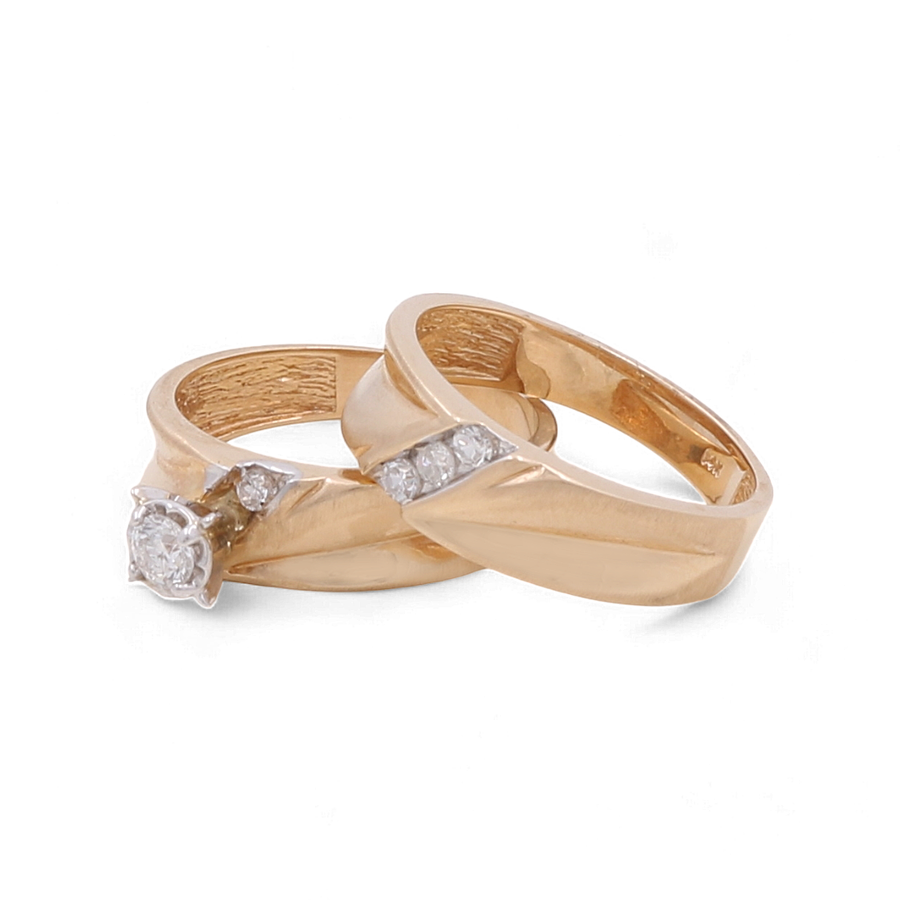 Two 14K yellow gold bridal rings from Miral Jewelry, each featuring diamond accents. One ring showcases a single round-cut diamond, while the other is adorned with small diamonds set in a row – perfect selections from the "14K Yellow Gold Bridal Woman Ring with Diamonds" collection.