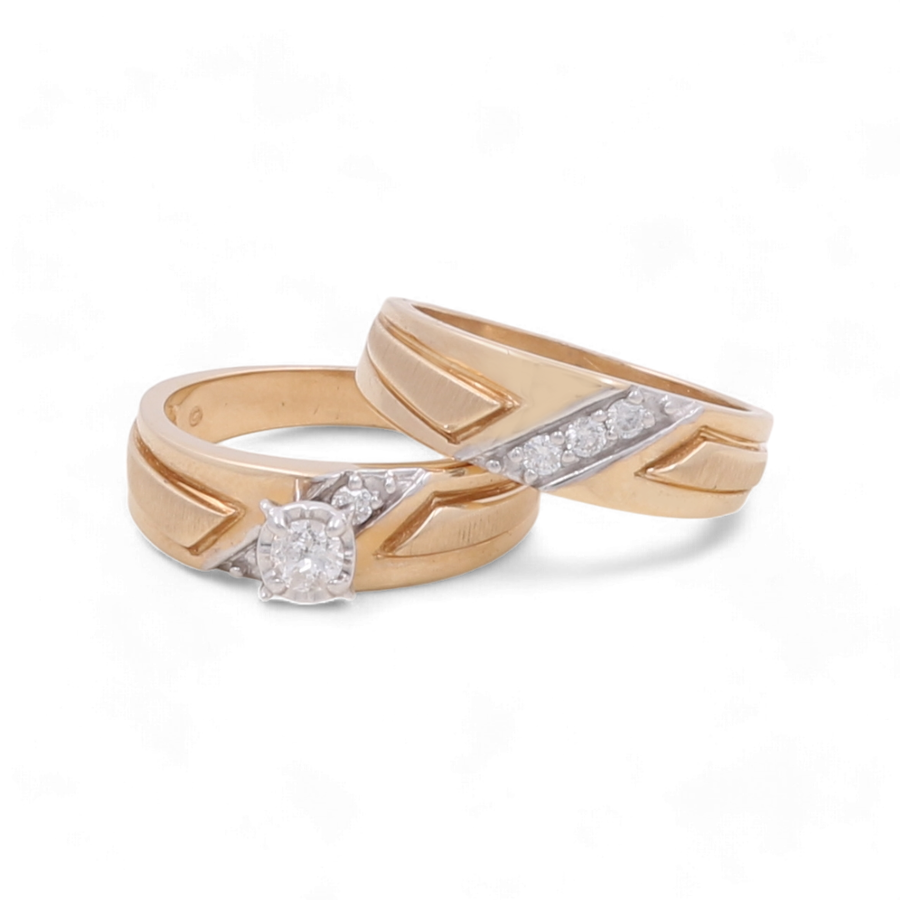 Two yellow gold bridal rings from Miral Jewelry's 14K Yellow Gold Bridal Woman Ring with Diamonds collection, one featuring a central round-cut diamond and diagonal white gold accents, and the other adorned with a row of smaller diamonds.