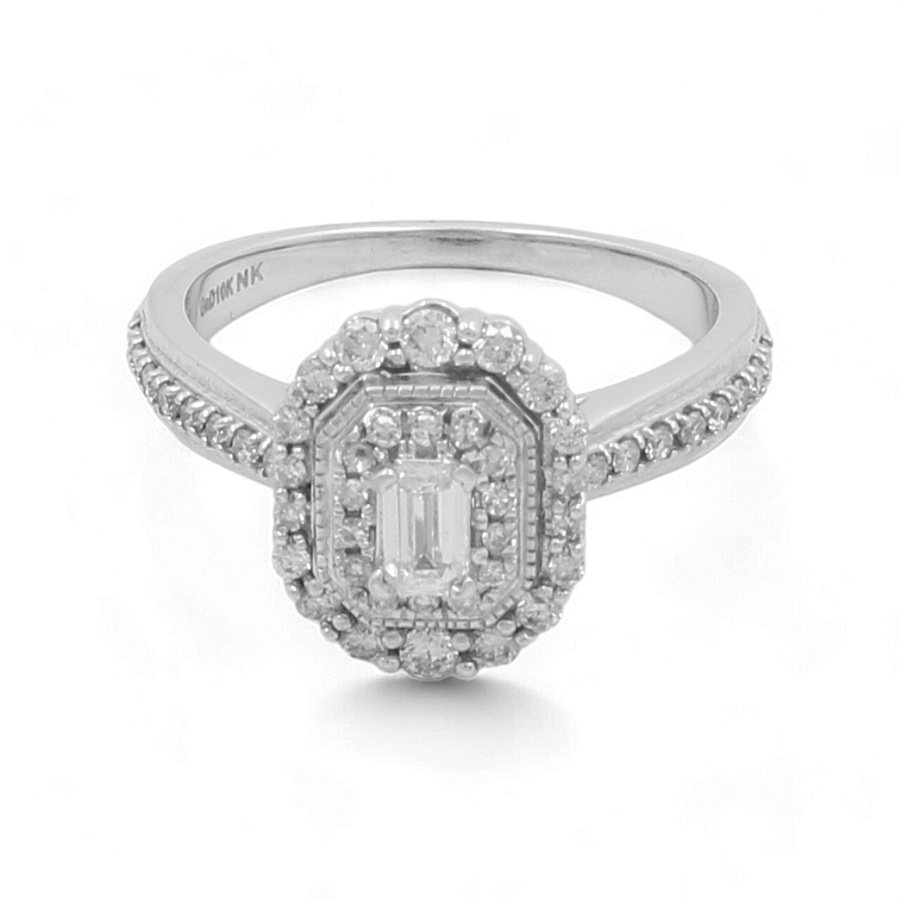 The 10K White Gold Bridal Woman Ring from Miral Jewelry features a central emerald-cut diamond surrounded by a double halo of smaller diamonds and additional diamonds along the band, offering an elegance that mirrors the beauty of a classic bridal ring.