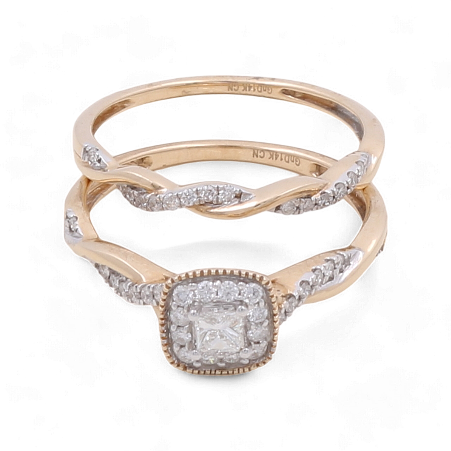 The 14K Yellow Gold Bridal Woman Ring with Diamonds from Miral Jewelry is a stunning set of two rings. One ring features a square-shaped diamond centerpiece, while the other showcases an elegant twisted band design. This exquisite wedding ring set perfectly embodies elegance and timeless beauty.