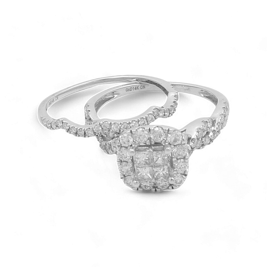 Introducing the 14K White Gold Bridal Woman Ring with Diamonds from Miral Jewelry: This elegant set features a two-ring ensemble. One ring boasts a cushion-cut diamond cluster, while the other showcases a diamond-studded band. Both rings are expertly crafted in exquisite 14K white gold, making them the perfect bridal wedding gift for that special woman in your life.