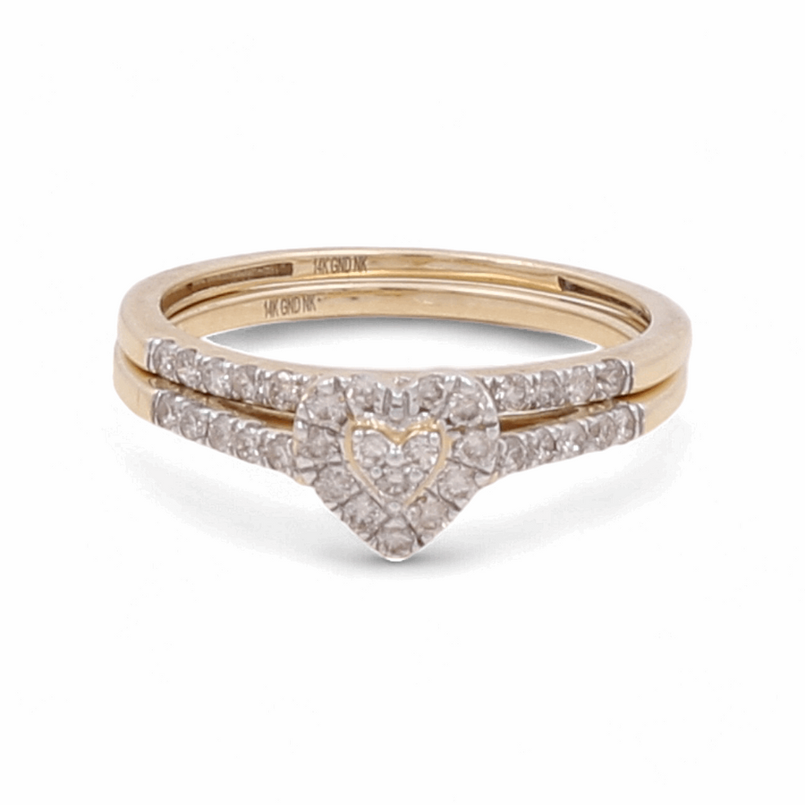 This 14K yellow gold bridal woman ring by Miral Jewelry features a heart-shaped diamond cluster centerpiece, surrounded by smaller diamonds and additional diamond accents on the bands, creating a timeless piece.