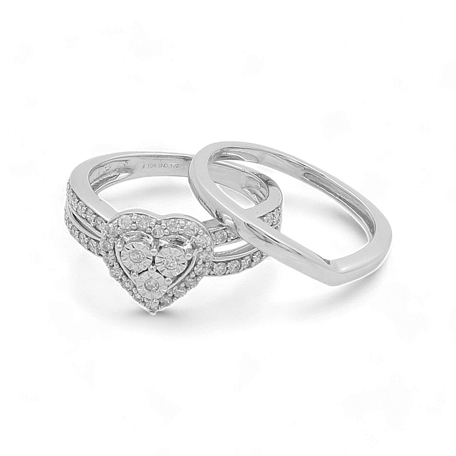 A luxurious 10K white gold bridal ring by Miral Jewelry, featuring a heart-shaped diamond surrounded by smaller diamonds and an elegantly plain band positioned to form an infinity symbol.