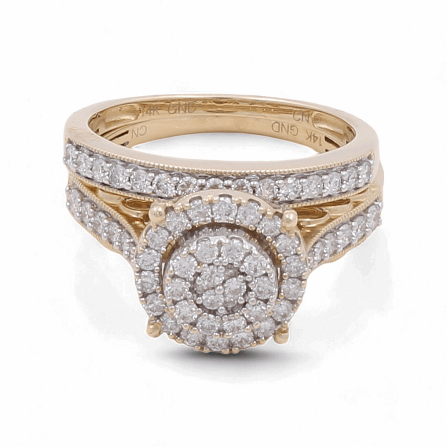 A stunning 14K yellow gold ring by Miral Jewelry, featuring a round cluster of diamonds surrounded by a halo of smaller diamonds, with additional diamonds set along the band. Ideal for a bridal woman's special day.