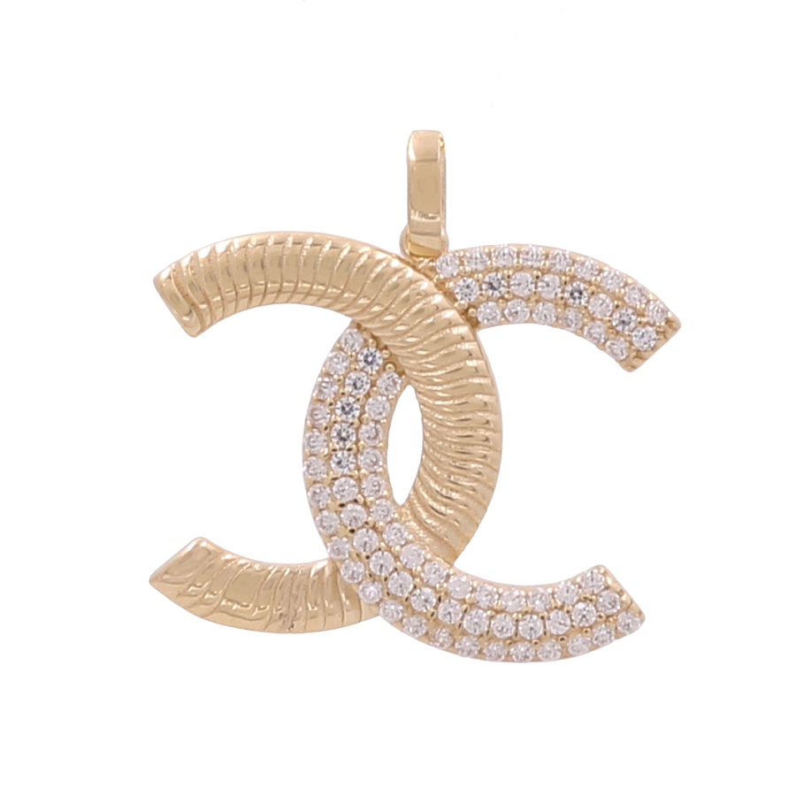 A stunning 10K Yellow Gold Fashion Pendant with Cubic Zirconias by Miral Jewelry featuring an interlocking double "C" design, partially encrusted with small diamonds.