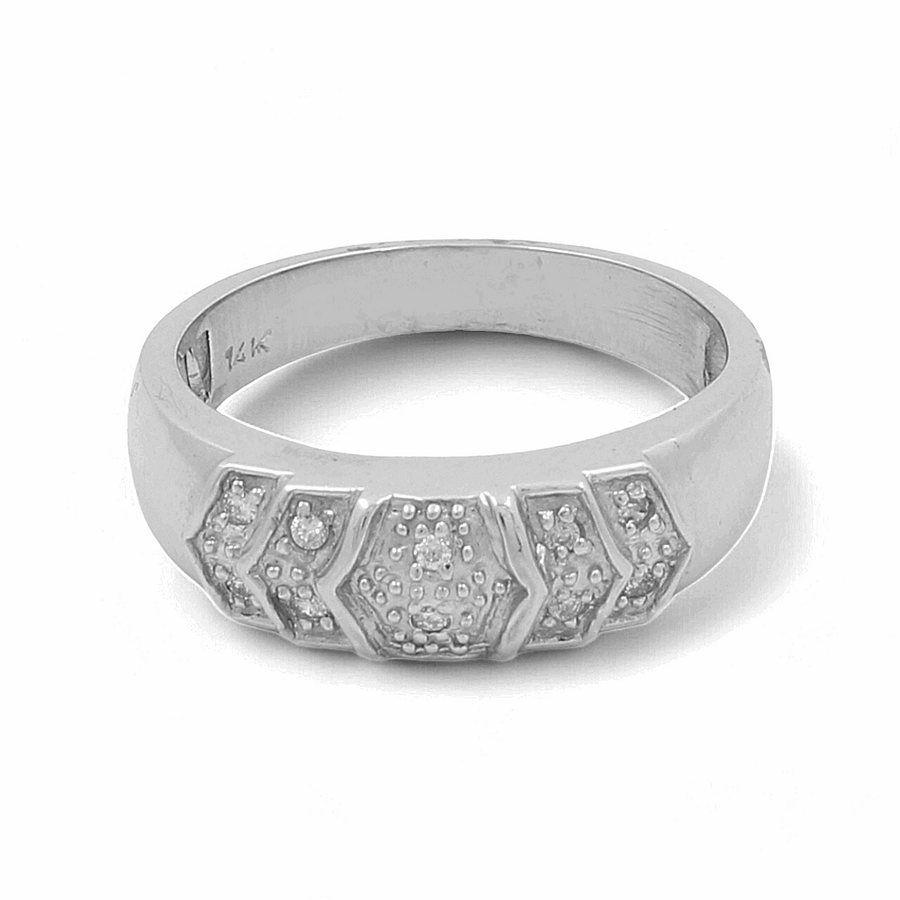 The 14K White Gold Bridal Men Ring with Diamonds by Miral Jewelry is a stunning piece featuring hexagonal, textured designs lined with small, embedded gems on the front. The inner band marked "14K" adds a touch of elegance and sophistication.