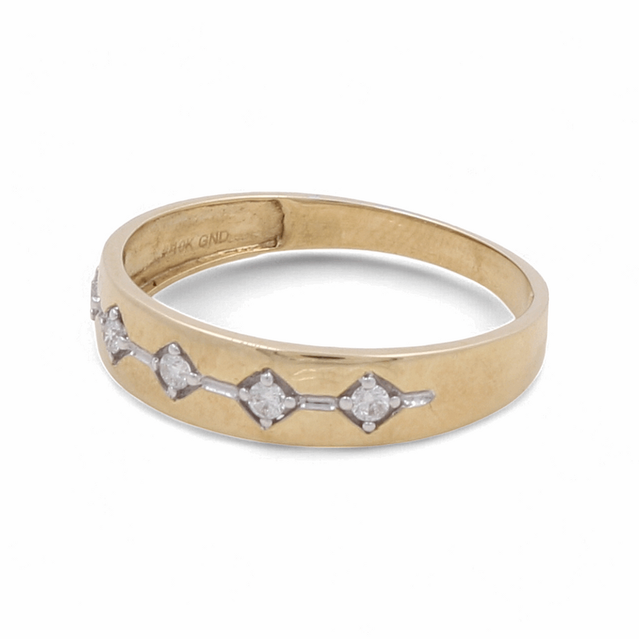 This **Miral Jewelry 10K Yellow Gold Bridal Men Ring with Diamonds** showcases a row of small diamonds artfully set in a pattern along its band.