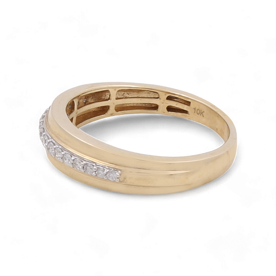 A beautiful piece by Miral Jewelry, the 10K Yellow Gold Bridal Woman Ring with Diamonds, is showcased on a white background. This exquisite ring features a row of small embedded diamonds, making it a perfect choice for any bride.