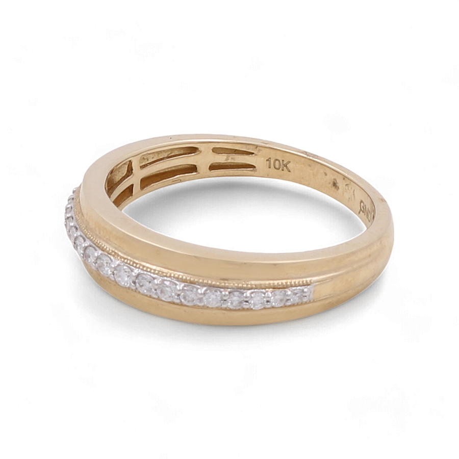 The 10K Yellow Gold Bridal Men Ring with Diamonds by Miral Jewelry showcases a row of small diamonds elegantly set in a channel along the top.