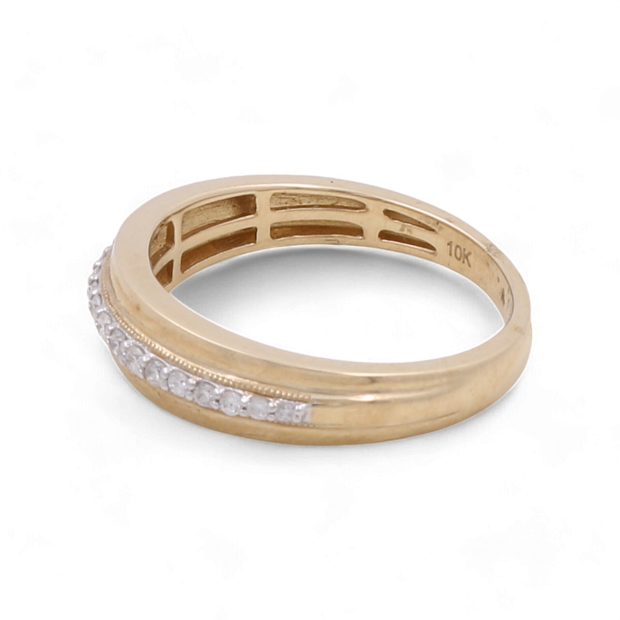 The Miral Jewelry 10K Yellow Gold Bridal Men Ring with Diamonds is a stunning piece crafted from 10K yellow gold, featuring a row of small embedded diamonds and an inscription inside the band that reads "10K.