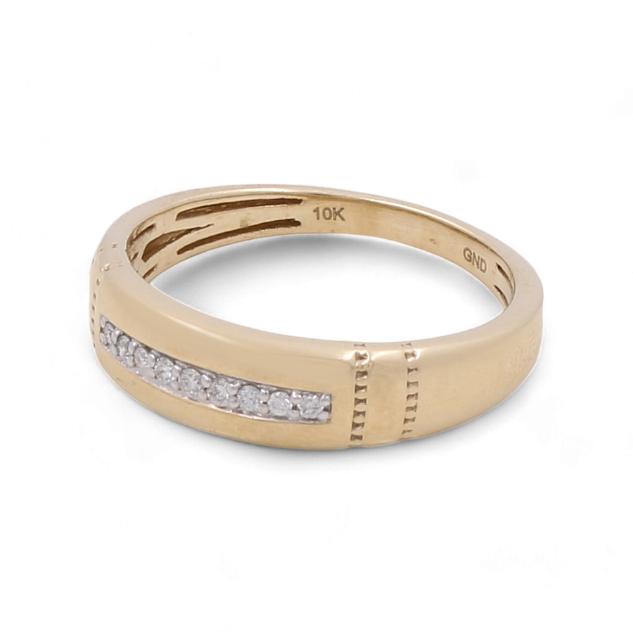 A men's bridal ring crafted by Miral Jewelry, made of 10K yellow gold and adorned with embedded diamonds, marked "10K" and "GND" on the inner band.