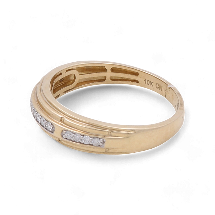 A 10K yellow gold bridal men's ring from Miral Jewelry, featuring a band adorned with a diagonal row of small certified diamonds and inscribed with "10K CN" on the inner side.